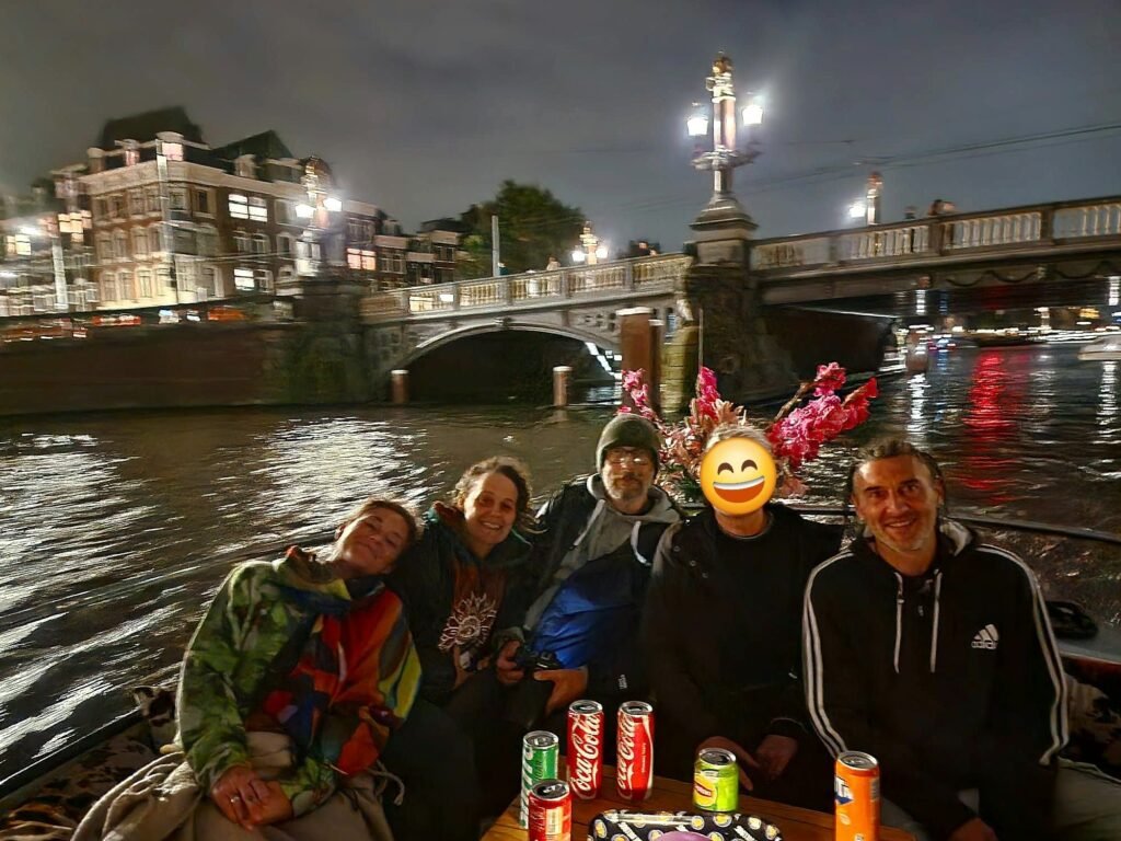 The Cosmic Tree community on a boat on an Amsterdam canal at night
